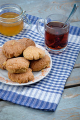 Tea, honey and honey cookies on wooden table