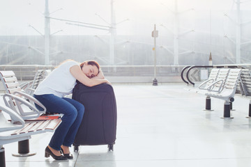 woman sleeping in the airport, transit passenger