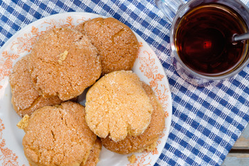Tea, honey and honey cookies on wooden table
