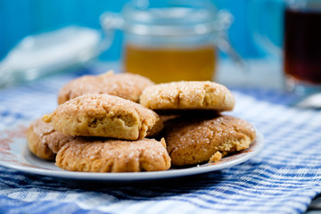 Tea, honey and honey cookies on wooden table