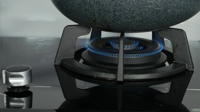 4k of Close-up hand switching a knop on a stove