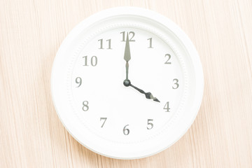 Fototapeta na wymiar White clock on wood wall