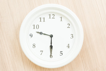 White clock on wood wall