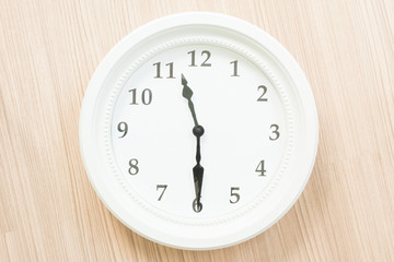 White clock on wood wall