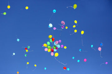 large number of colorful balloons against the blue sky