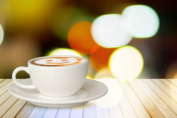 Cups of smile coffee on white wood table on colorful abstract.