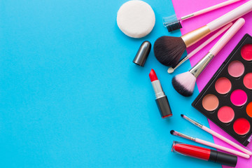 Beauty and fashion concept with set of cosmetics on blue and pink background