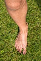 One heathy leg of man in the grass