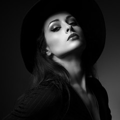 Glamour sexy makeup woman posing in fashion hat on dark backgrou