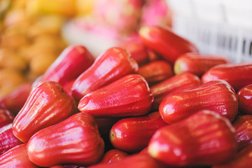 Tropical fruits. Pink apples on the market.