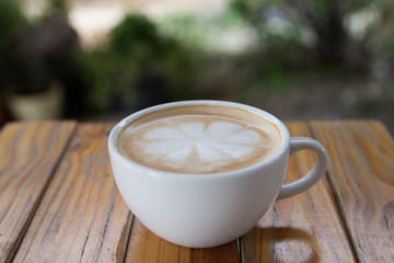 Cup of cappuccino art coffee with froth shape flower