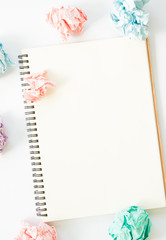 Blank notebook and crumpled paper