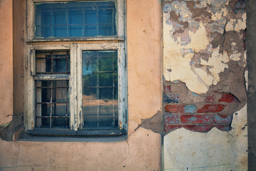 Old window in an abandoned building. The details of the old dilapidated buildings. The wall of the building. Background in grunge style