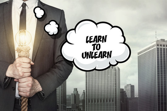 Learn to unlearn text on speech bubble with businessman