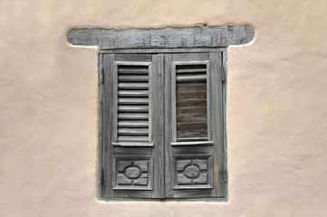 Closed window and shutter on ancient wall
