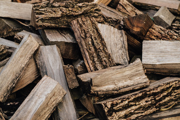 Firewood background - chopped firewood on a stack
