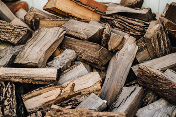 Firewood background - chopped firewood on a stack
