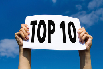 top 10, hands holding sign in blue sky