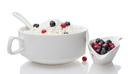 Plate of cottage cheese with sour cream and fresh blueberries