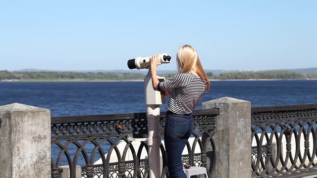 Young beautiful blonde woman in a striped blouse, summer outdoors