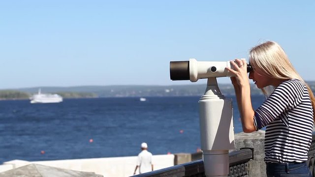 Young beautiful blonde woman in a striped blouse, summer outdoors