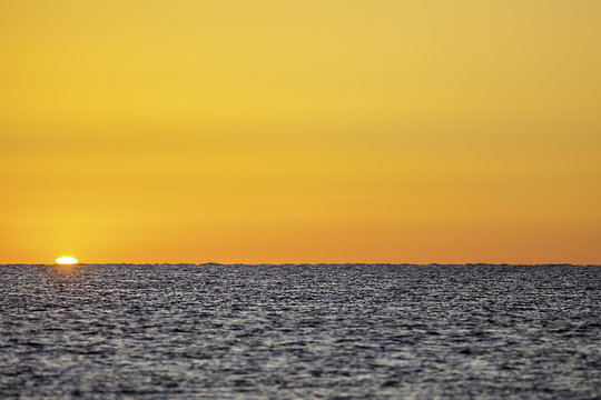 New Day Horizon - plain image of a tranquil sea at sunrise. Useful for copy or montage.