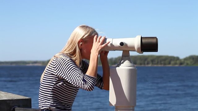 Young beautiful blonde woman in a striped blouse, summer outdoors