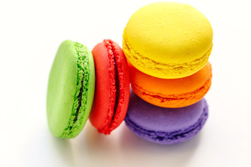 pile of colorful and tasty french macaroons on white background