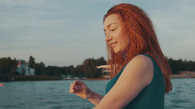 Red hair happy girl in motor boat. Enjoy summer evening. Entertainment. Scenery. Nature