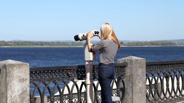Young beautiful blonde woman in a striped blouse, summer outdoors