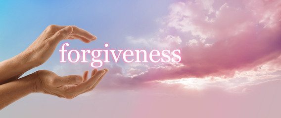 Forgive and release to your Higher Power - female hands gently cupped around the word FORGIVENESS on a soft blue sky background with a beautiful fluffy pink cloud stream and sun light - obrazy, fototapety, plakaty