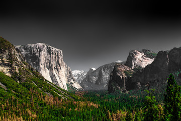 Dark dramatic depiction of Yosemite National Park at iconic Valley View with El Captain 