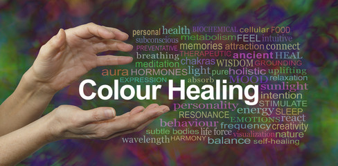 Colour Healing Therapy Website Banner  -  Female hands sensing the words COLOUR HEALING surrounded by a relevant word cloud on a multicolored background 