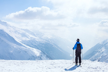 Fototapeta na wymiar skiing background, skier in beautiful mountain landscape, winter holidays in Alps
