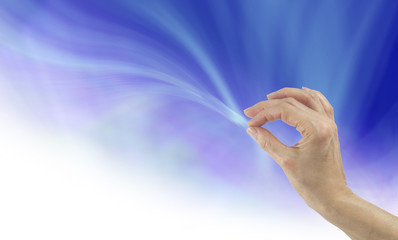 Energy flows where your intention goes -  Female hand appearing to be touching a stream of energy...