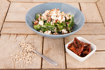 Spinach, dried tomatoes, feta cheese and sunflower seeds salad