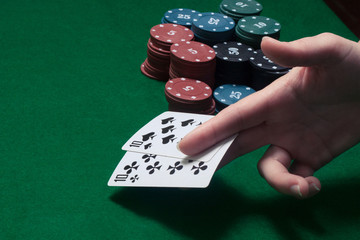 two cards of the player's hand at the game table with chips