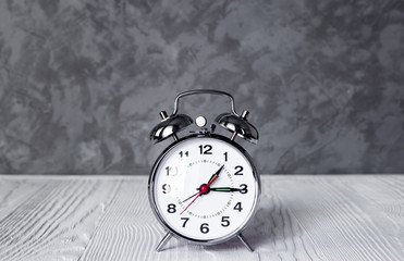 alarm clock at empty locker on white background