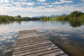 Fototapeta na wymiar lake with mountains and boardwalk