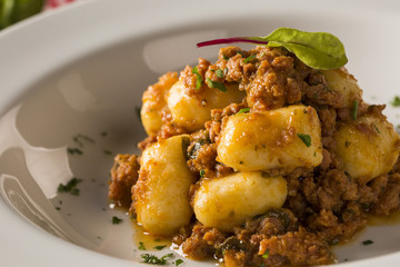 Portion of gnocchi in tomato sauce with cheese.