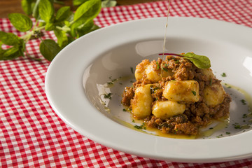 Portion of gnocchi in tomato sauce with cheese.