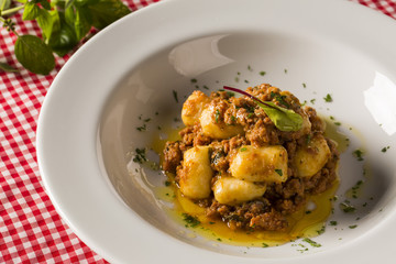 Portion of gnocchi in tomato sauce with cheese.