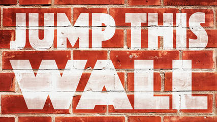 Jump This Wall Written On A Brick Wall