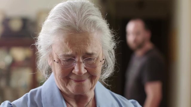 A senior woman who is a victim of elder abuse is in fear while an abusive man glares at her. Shot in 4K UHD.
