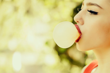 Woman with chewing gum bubble