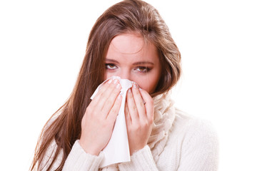 Sick woman girl with fever sneezing in tissue