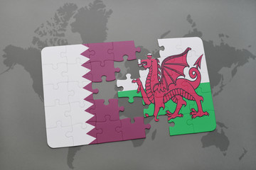 puzzle with the national flag of qatar and wales on a world map background.