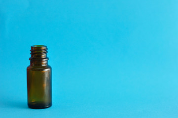 A small brown bottle isolated on a blue background