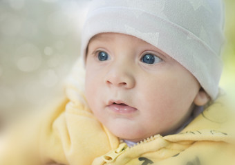 portrait of a child in a knitted hap