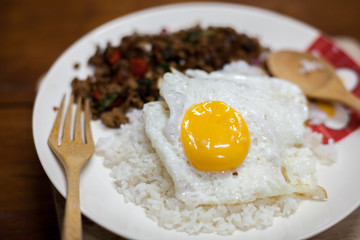 Rice topped with stir-fried pork and basil with Fried egg